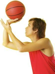man shooting a basketball